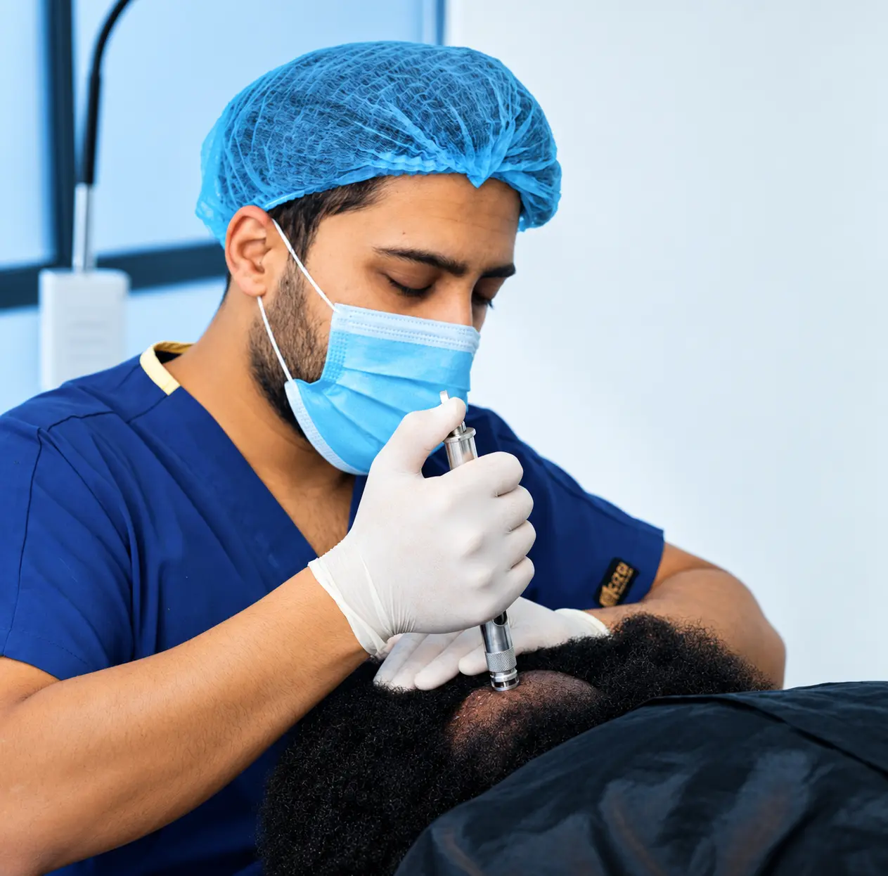 Specialist performing a close hair restoration procedure on Afro-textured hair in Kampala
