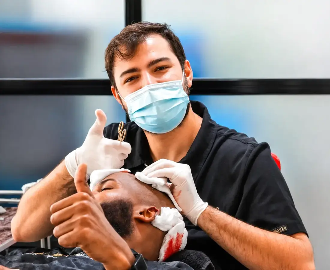 Hair transplant specialist caring for an African patient